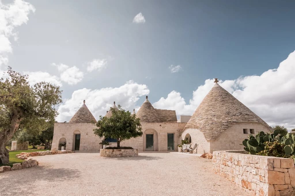 Dimora Dieci Coni villa exterior with ten trulli cones and olive trees, Cisternino, Italy