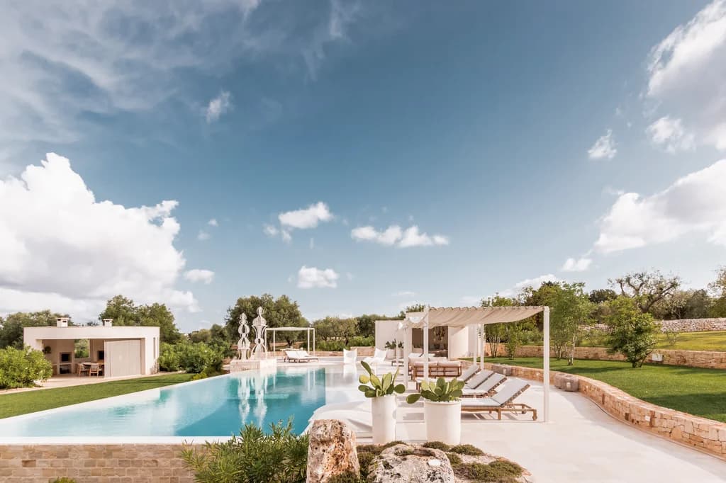 Dimora Dieci Coni outdoor pool with sun loungers and olive trees, Cisternino, Italy