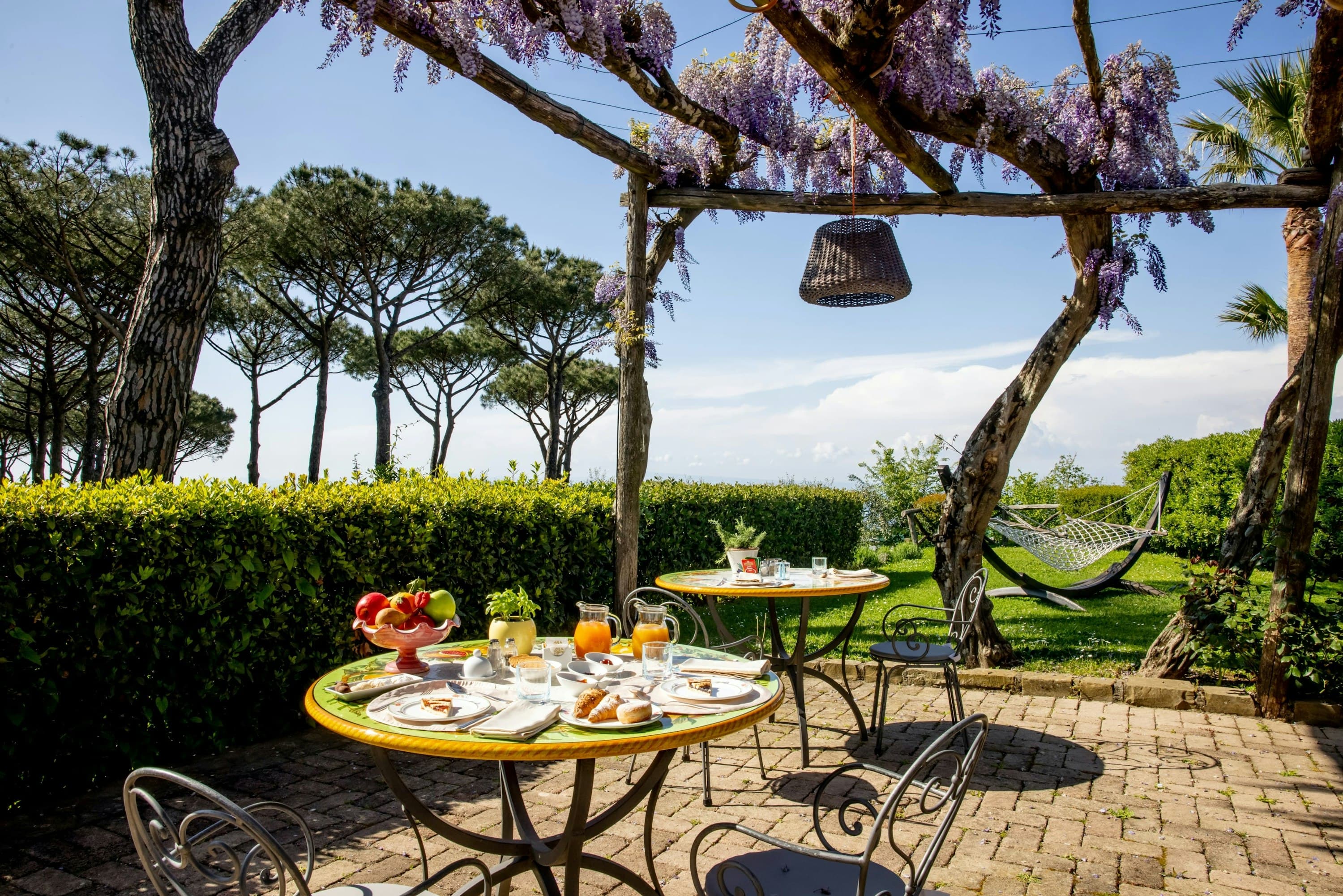 Pavillion Paradiso outdoor dining terrace with wisteria pergola, Massa Lubrense, Amalfi Coast, Italy