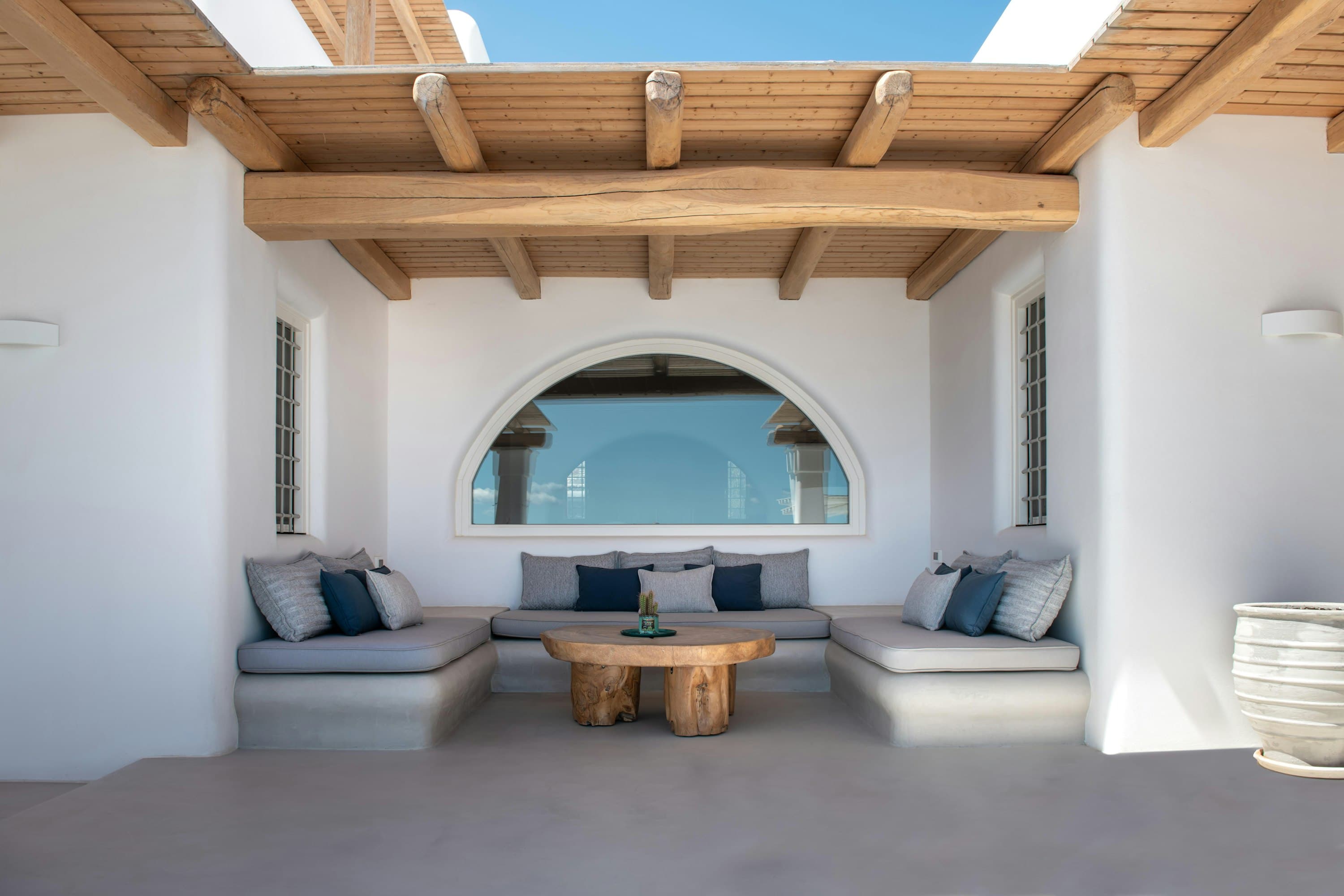 Whisper Of The Sea covered terrace with built-in seating and sea views, Imerovigli, Greece