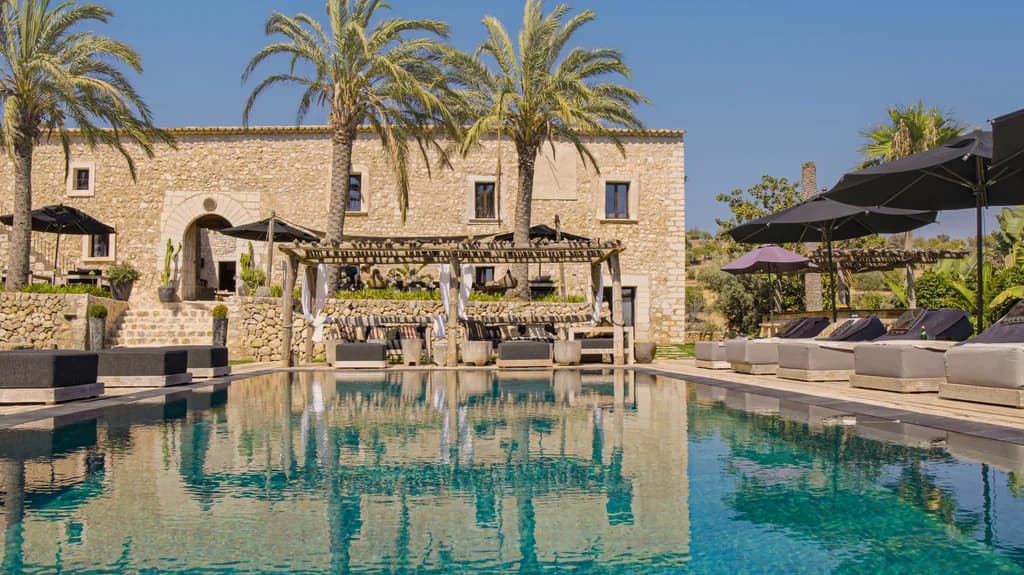 Spirit of Son Fuster outdoor pool with stone manor reflections, Campanet, Majorca, Spain