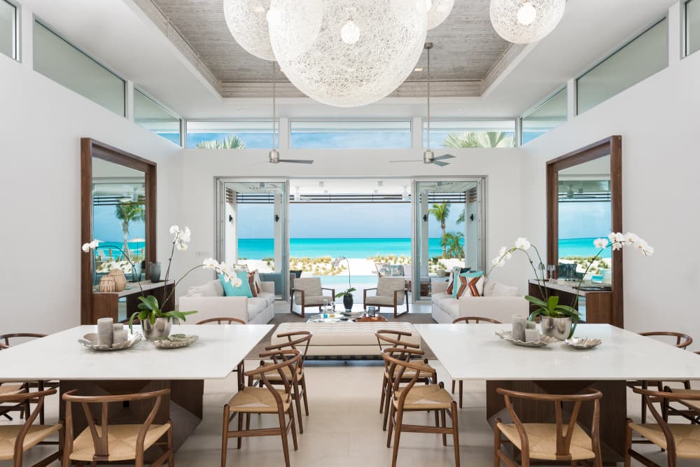 Sentosa villa formal dining room with marble tables and ocean views, Grace Bay, Turks and Caicos