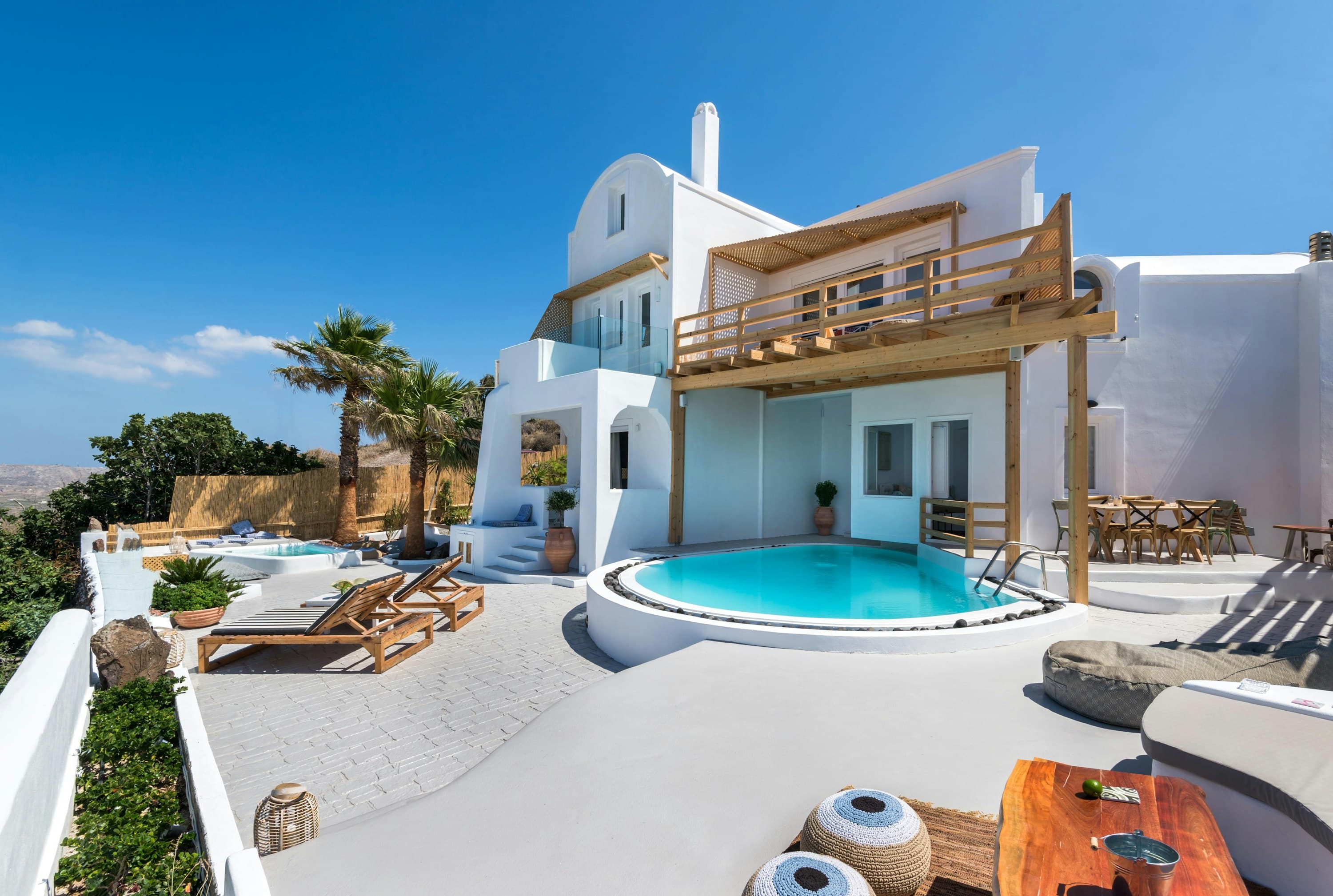 Hand of Hygieia villa exterior with curved pools and pergolas, Santorini, Greece