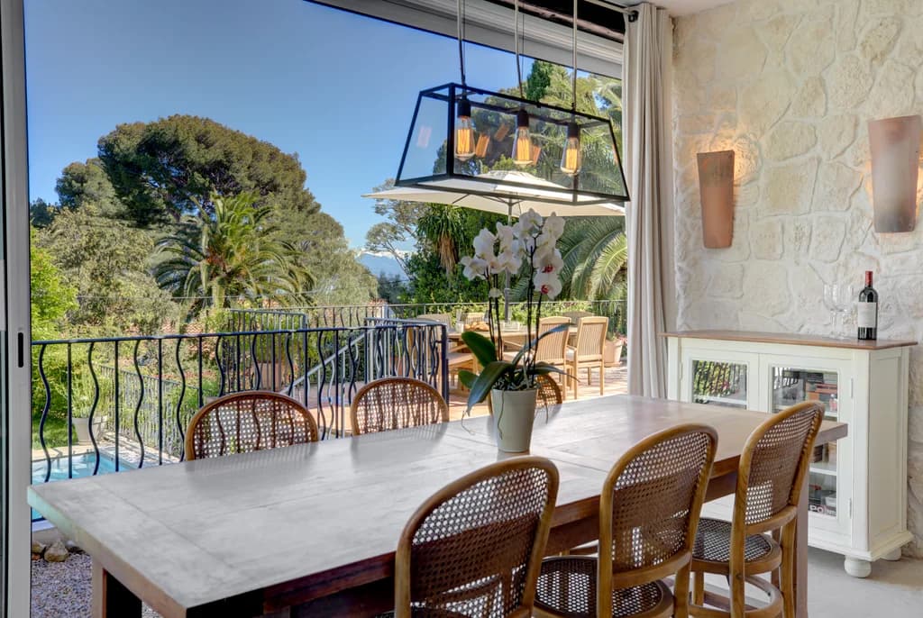 Villa Cuvier indoor dining room with marble table and pool terrace doors, Cap d'Antibes, France