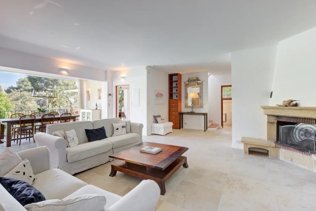Villa Cuvier living room with limestone fireplace and travertine floors, Cap d'Antibes, France