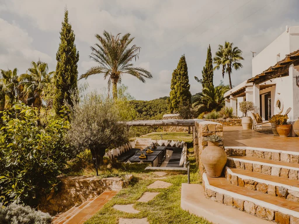 Finca Tranquila whitewashed villa exterior with stone terracing and gardens, Ibiza, Spain