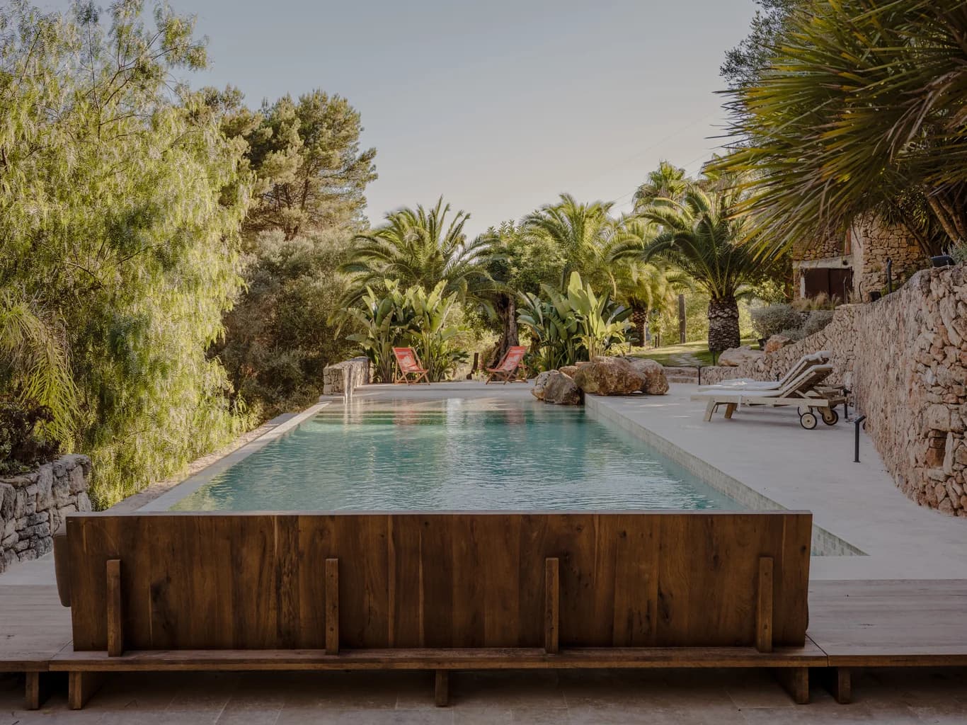 Finca Tranquila lap pool with reclaimed wood surround and stone terraces, Ibiza, Spain
