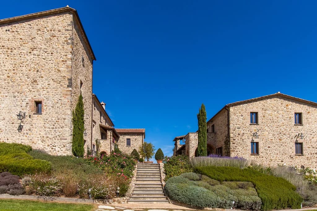 Villa Chianina courtyard with stone staircase, lavender, roses and cypress trees, Fabro, Italy