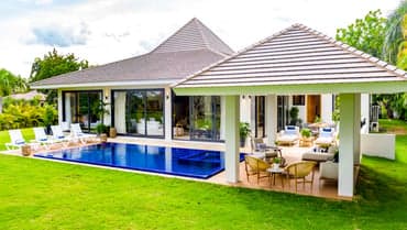 Villa Dolfina Cuartetera garden facade with conical rooflines and poolside terrace, La Romana, Dominican Republic