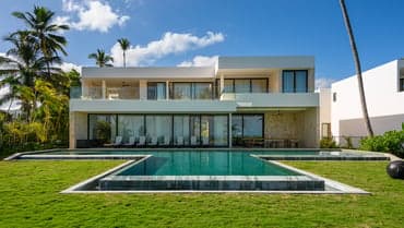 Villa Dolfina Cuartetera rear facade with lap pool and palm-lined lawn, La Romana, Dominican Republic