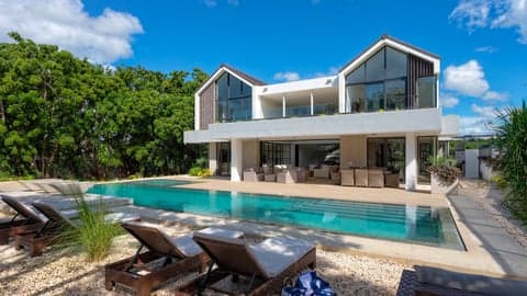 Villa Dolfina Cuartetera front facade with A-frame rooflines and private pool, La Romana, Dominican Republic