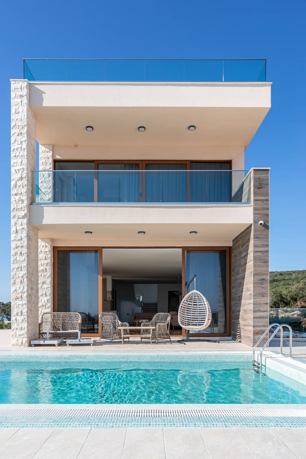 Villa Edela luxury exterior with pool terrace and glass balconies, Budva, Montenegro