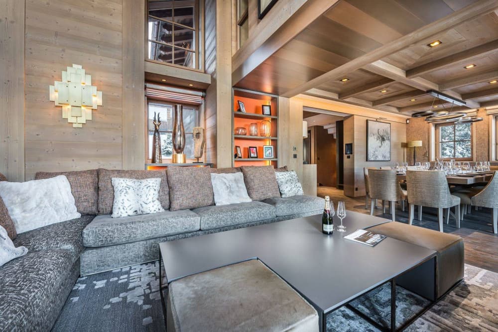 Courchevel 7 open-plan living room with timber beams and sectional seating, Courchevel 1850, France