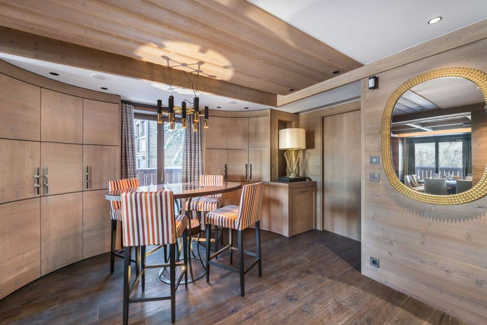 Courchevel 7 private bar with gold sunburst mirror and curved cabinetry, Courchevel 1850, France