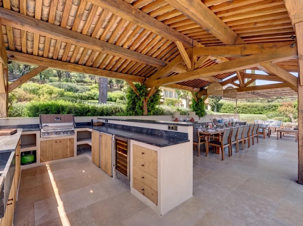 Villa Vignoble outdoor kitchen with BBQ, marble counters and timber cabinetry, Grimaud, France