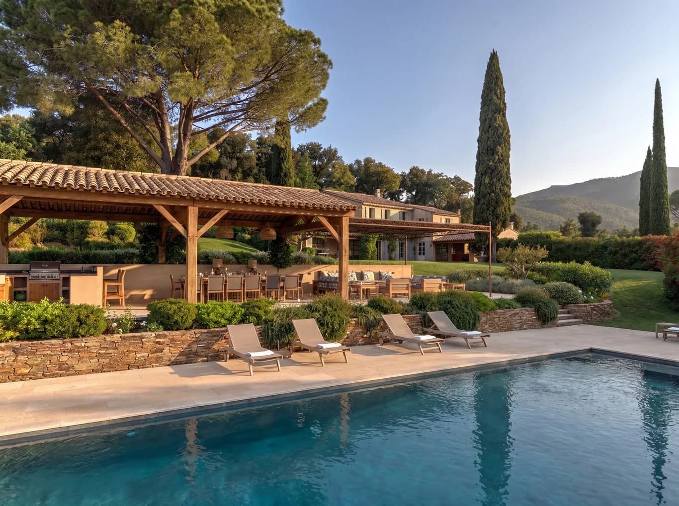 Villa Vignoble exterior with pool and cypress trees at golden hour, Grimaud, France