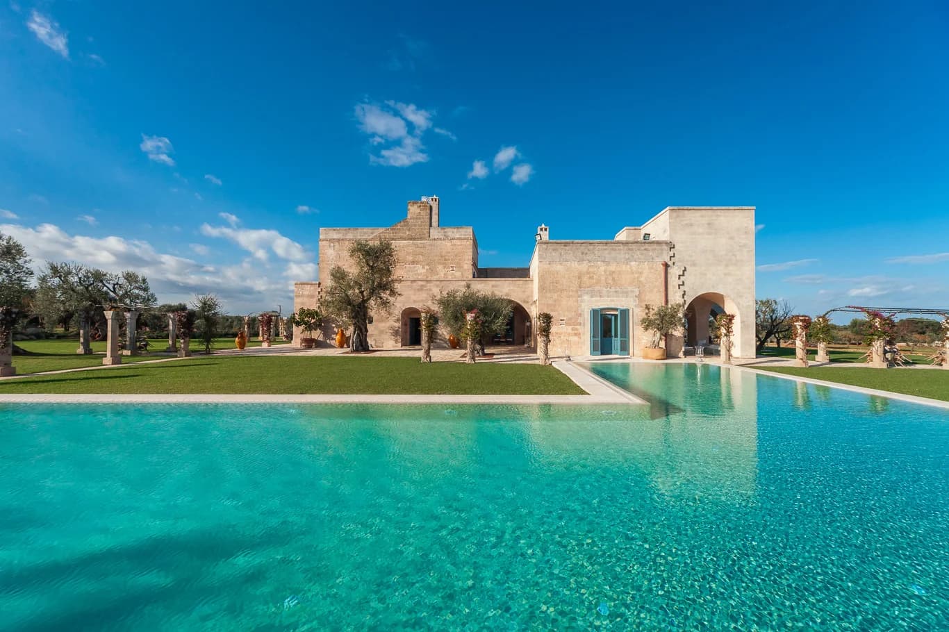 La Residenza villa exterior with turquoise pool reflecting historic masseria facade, Savelletri, Italy