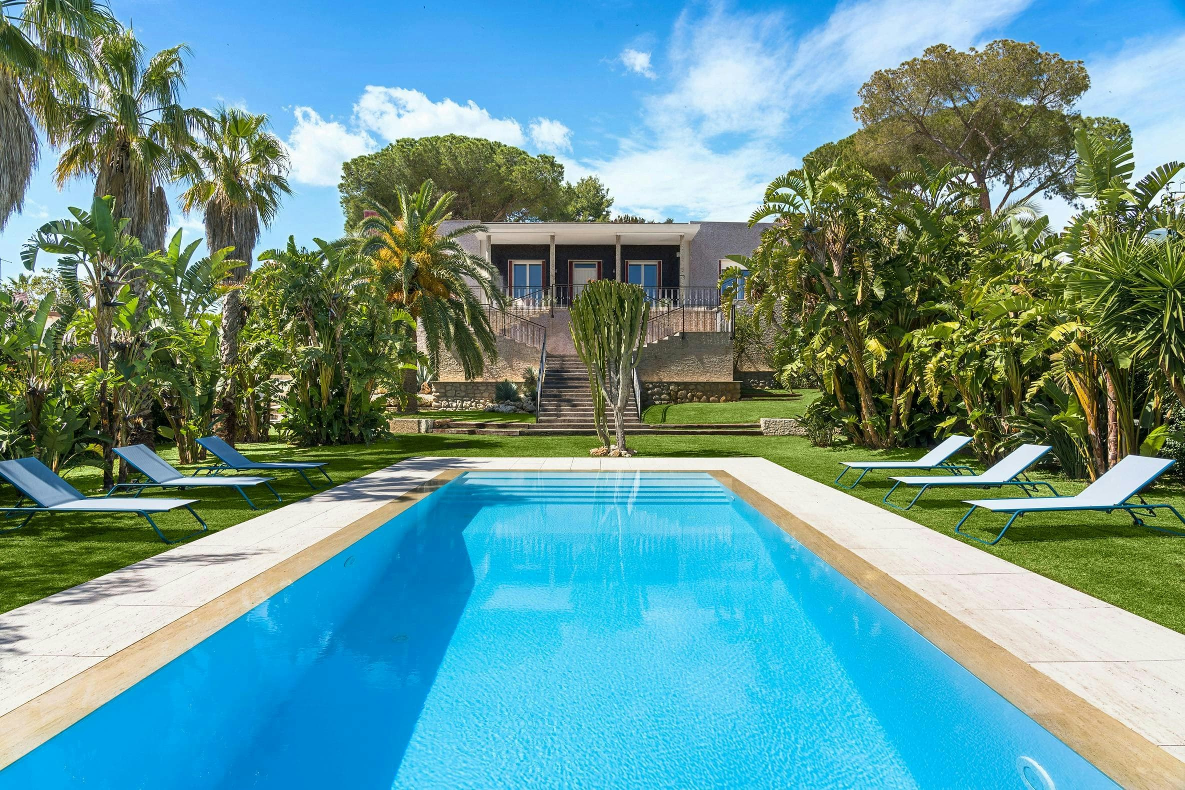 Sicilian Song villa exterior with pool and tropical palms, Fontane Bianche, Sicily, Italy