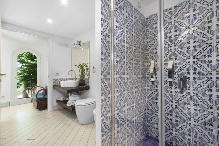The Italian Pearl ensuite bathroom with patterned tiles and vessel sink, Sorrento, Amalfi Coast, Italy