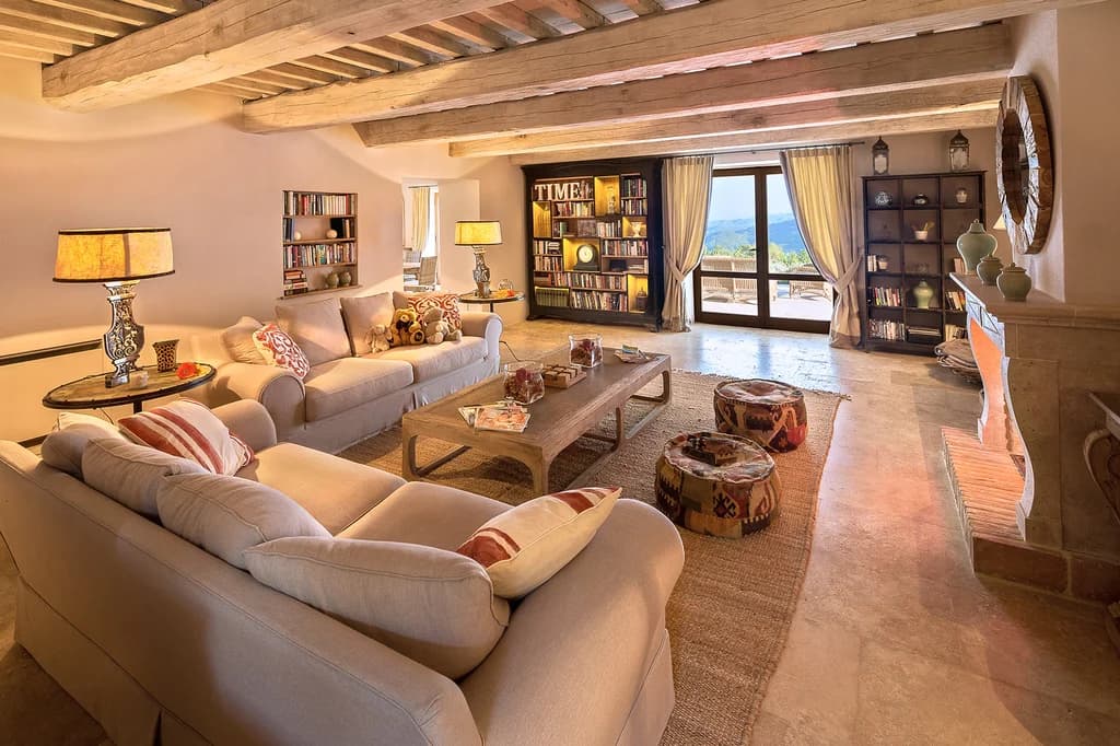 Villa Elceto living room with beamed ceiling, travertine fireplace and mountain views, Umbertide, Italy
