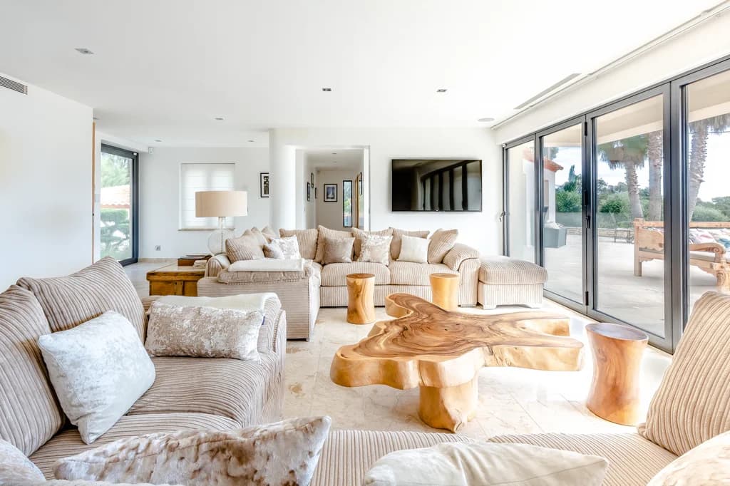 Villa Riviera living room with glass doors opening to terrace, Bay of St. Tropez, France